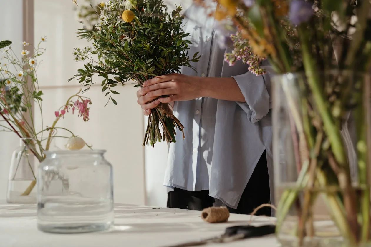 Person holding a cheerful yellow flower bouquet as a gift