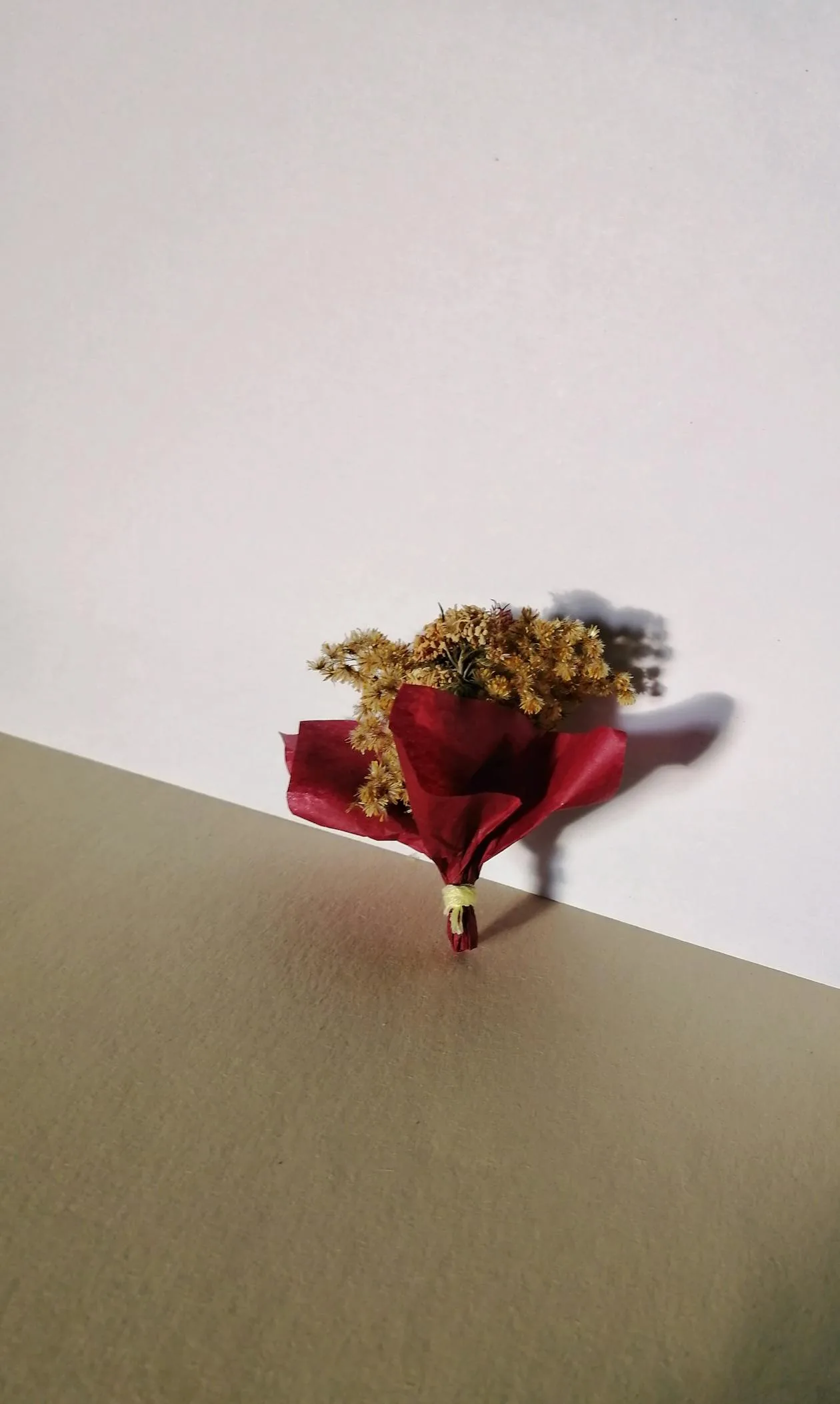 A bunch of dried flowers wrapped in paper as a thoughtful gift