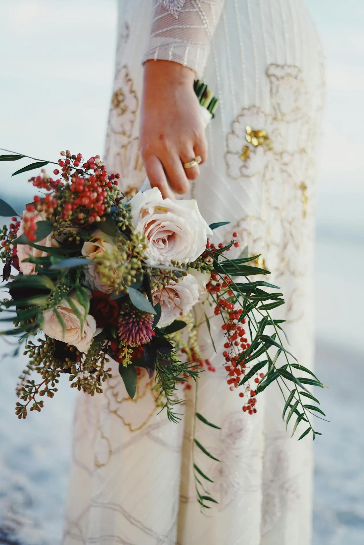 A woman holding a bouquet of flowers in celebration